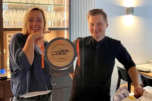 Marlen Kempf und ihr Küchenchef Dominik Golabek mit dem begehrten Teller. Er zeigt Gästen des Parkbads Süd, dass sie erfolgreich bei der Show „Mein Lokal, Dein Lokal“ war.