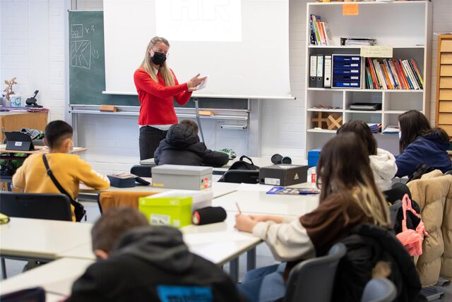 Eine Lehrerin unterrichtet in einem Klassenraum