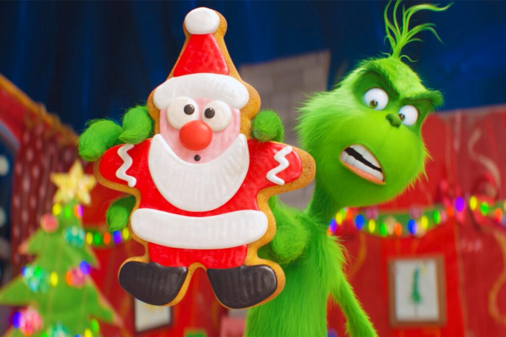 Der Grinch im Animationsfilm hält einen Lebkuchennikolaus hoch. Der Grinch im Animationsfilm hält einen Lebkuchennikolaus hoch.