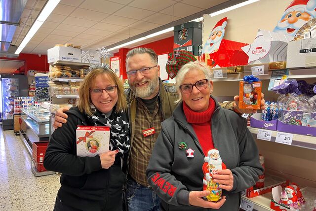 Gregor Koppers, Monika Wittwer und Annette Piotrowski vor dem Weihnachtsregal im Rewe Te-Ko.