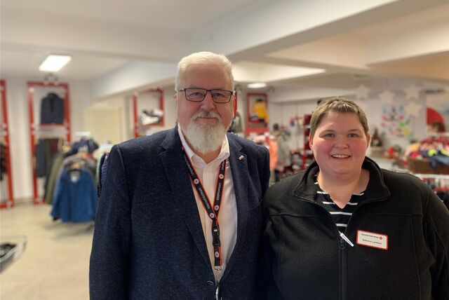 Christoph Behrenspöhler und Sabrina Lankers stehen im neu eröffneten Kleidershop des Deutschen Roten Kreuzes in Castrop-Rauxel. Im Hintergrund sind Kleiderständer mit Klamotten zu sehen.