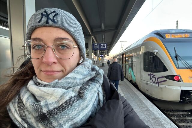 Anna Katharina Wrobel vor einem Zug am Dortmunder Hauptbahnhof.