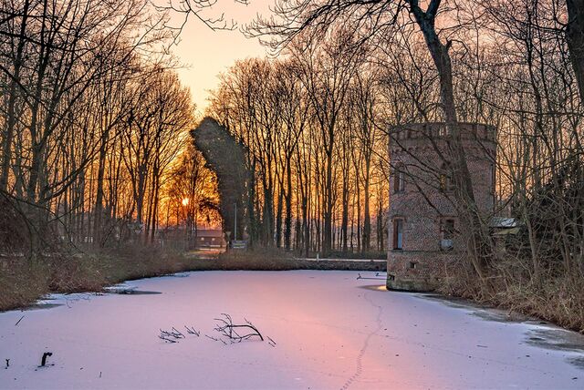 Schloss Bladenhorst in Castrop-Rauxel im Schnee bei Sonnenuntergang.
