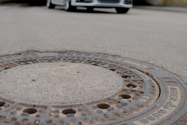 Ein Gullydeckel auf einer Straße (Symbolbild)