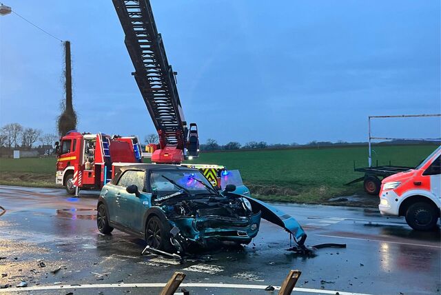 Ein zerstörtes Auto steht auf einer Straße.