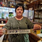 Bärbel Luczak, Wirtin der Kneipe Oase in Datteln, hält ein Schild mit Datum hoch.