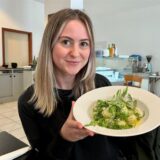 RN-Volontärin Julia Segantini sitzt im Restaurant „Pasta Buonissima“ in Dortmund und hält einen Teller mit Gnocchi in den Händen.