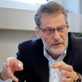 Bernhard Klocke in einer Gesprächssituation und eine kleine PV-Anlage an einem Balkon