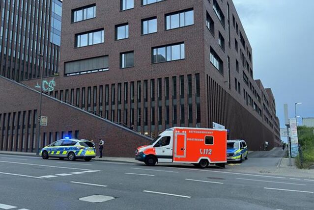 Zwei Polizeiwagen und ein Rettungswagen stehen an einer Straße neben dem Robert-Schuman-Berufskolleg, in der Nähe des Dortmunder U.