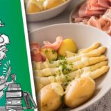 Spargel, Kartoffeln und Schinken liegen auf einem Teller.