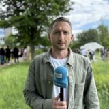 RN-Reporter Philipp Pohl steht mit einem Mikrofon vor dem Protestcamp an der FH Dortmund.