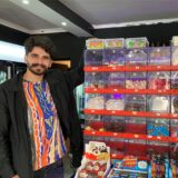 Sores Ekinci steht in seinem Vintage Kiosk in der Altstadt von Recklinghausen neben Schubfächern, in denen verschiedene Weingummi-Sorten liegen.