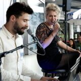 Mann und Frau mit Mikrofonen, die singen