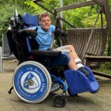 Ein Mann sitzt in einem Rollstuhl und reckt beide Daumen nach oben. Er trägt ein Bochum-Trikot und auch die Rollen seines Stuhls ziert das Logo des Vereins.