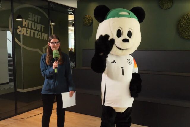 Volontärin Katharina Göke steht neben dem Panda.