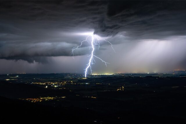 Gewitterwolke mit Blitz am Horizont.