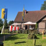 Mit Fahnen geschmücktes Heimathaus
