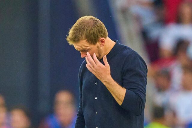 Bundestrainer Julian Nagelsmann reibt das linke Auge.