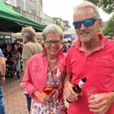 Ein Mann und eine Frau stehen auf der Kranzplatte mit Getränken in der Hand.