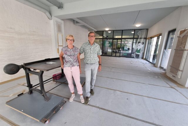 Ein Mann und eine Frau stehen in einem leeren Ladenlokal.