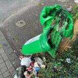 Ein verschmorter Mülleimer mit Unrat darunter.