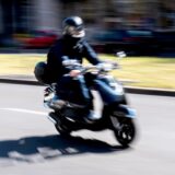 Ein Mann fährt auf einem Motorroller.