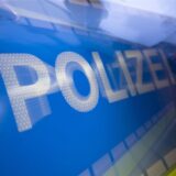 Tür eines Streifenwagens mit der Aufschrift „Polizei“.