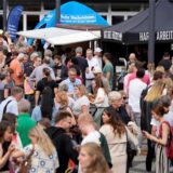 Besucher stehen beim Feierabendmarkt in Dortmund auf dem Theater-Vorplatz.