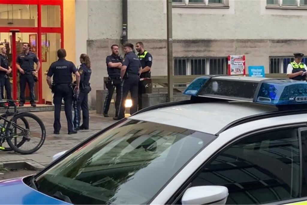 Einsatzkräfte der Polizei stehen vor einem Supermarkt im Münchner Stadtteil Sendling.