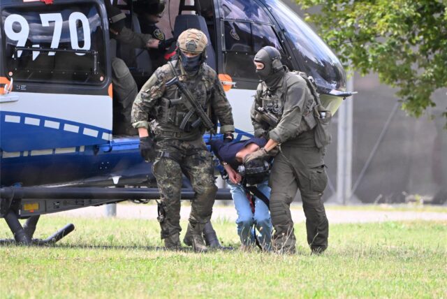 Der mutmassliche Täter des Messerangriffs von Solingen wird von einem Hubschrauber zu einer Wagenkolonne geführt. Diese bringt ihn zum Ermittlungsrichter des Bundesgerichtshof (BGH), der über einen Haftbefehl entscheiden wird.