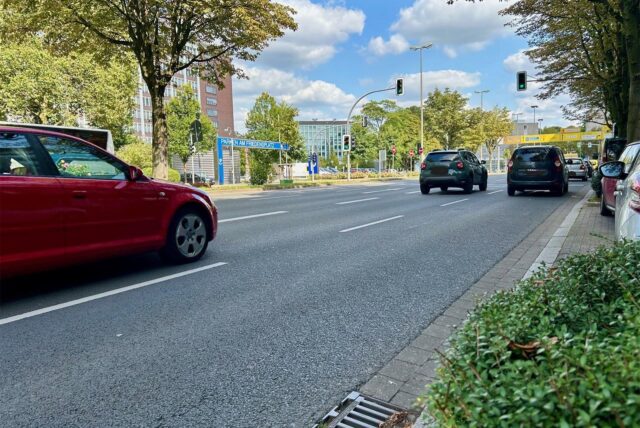 Autos fahren auf dem Wall in Dortmund an der Einfahrt zur Tiefgarage Friedensplatz vorbei.