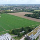 Der mögliche Plan B aus der Vogelperspektive, aufgenommen am 26. August 2024: An die Gebäude der Fachhochschule am Campus-Nord (unten) schließt sich Ackerfläche an. Wenn aus dem Umzug ins Hafenquartier nichts werden sollte, gibt es zwei Alternativen. Eine davon ist die Bebauung dieser Fläche.