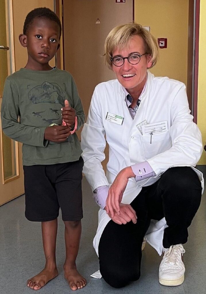 Der fünfjährige Kiame mit Dr. Katrin Rosery vor der Operation