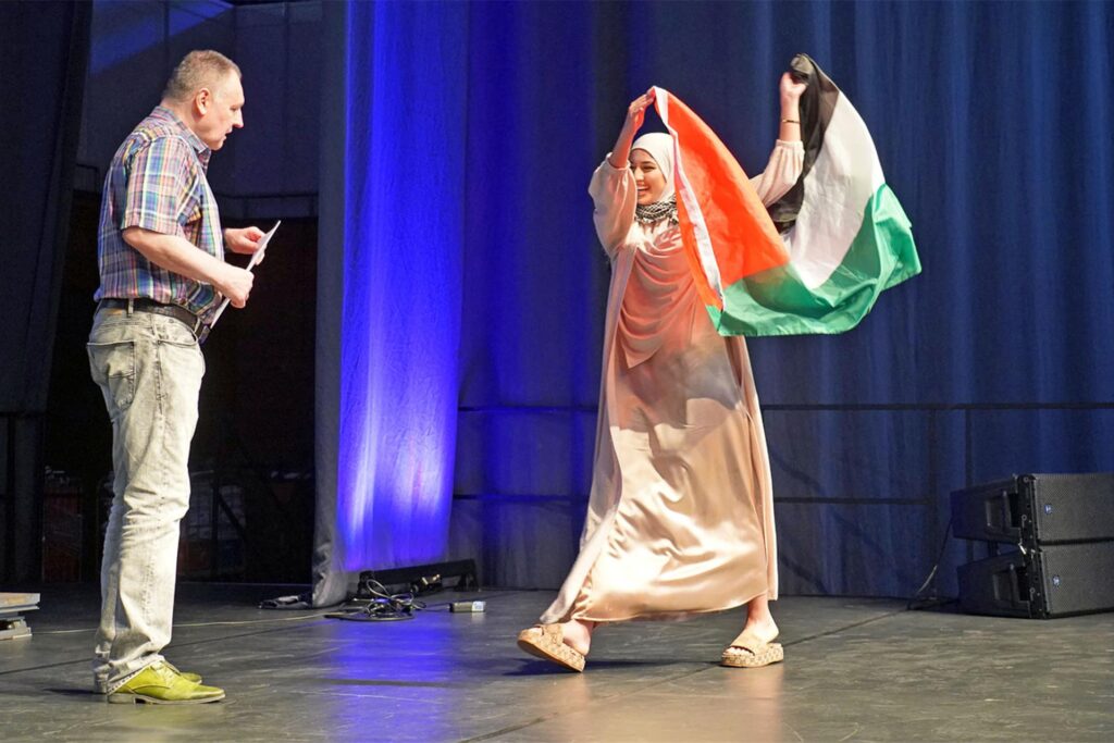 Diana Darwish Zade mit Palästina-Flagge bei der Zeugnisübergabe an die Abiturienten des Ernst-Barlach-Gymnasiums. Schulleiter Dr. Friedrich Mayer war mit ihrem Verhalten nicht einverstanden. Die CDU in Castrop-Rauxel forderte ein politisches Nachspiel. Diana Darwish Zade mit Palästina-Flagge bei der Zeugnisübergabe an die Abiturienten des Ernst-Barlach-Gymnasiums. Schulleiter Dr. Friedrich Mayer war mit ihrem Verhalten nicht einverstanden. Die CDU in Castrop-Rauxel forderte ein politisches Nachspiel.