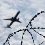 Ein startendes Flugzeug, im Bild-Vordergrund Stacheldraht (Symbolbild).