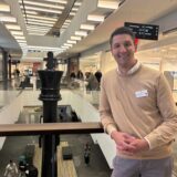 Centermanager Gerrit Beckmann steht in einem Gang des Palais Vest in Recklinghausen. Er lehnt an einer Brüstung.