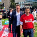 Nordrhein-Westfalens Ministerpräsident Hendrik Wüst (CDU, M) und Tekin Nasikkol, Konzernbetriebsratsvorsitzender von Thyssenkrupp, kommen zu einer Demonstration vor dem „Nationalen Stahlgipfel“ des Wirtschaftsministeriums von Nordrhein-Westfalen vor der Mercatorhalle.