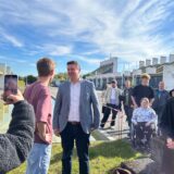 TikTok-Star Levi Penell und Bürgermeister Rajko Kravanja unterhalten sich, während eine der Schaulustigen sie mit ihrem Smartphone filmt.