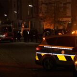 Polizisten stehen neben einem Einsatzfahrzeug.