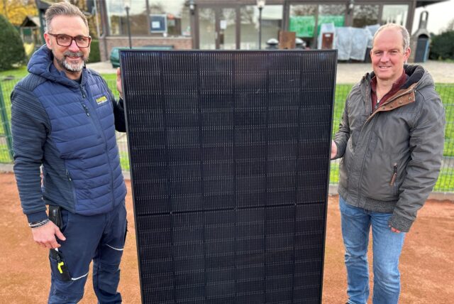 Veit Sand (Marketing und Vertrieb von der Sabosol GmbH) und Thomas Bikowski (Vorsitzender vom SuS Tennis Hervest Dorsten) präsentieren ein Modul eines Balkonkraftwerkes, das auf dem Dach des Vereinsheims installiert werden soll.