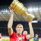 Arjen Robben von Bayern München reckt den Pokal in die Höhe und bedankt sich nach dem Spiel bei den Fans.