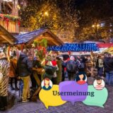 Auf dem Dortmunder Weihnachtsmarkt stehen viele Menschen an Stehtischen.