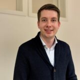 Tom Roehl, FDP-Politiker aus Castrop-Rauxel, steht vor einer weißen Wand.