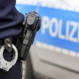 Polizist mit Waffe und Handschellen