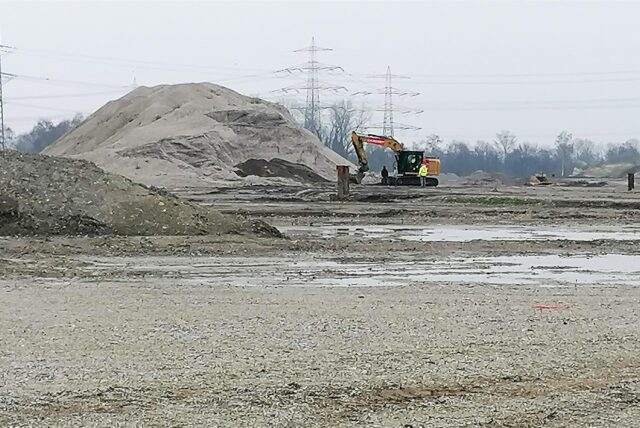 Im März 2024, als dieses Foto entstand, war der Bagger noch recht einsam auf dem Gelände. Inzwischen hat die Firma Hagedorn hier wieder einen recht umfangreichen Fuhrpark an Baumaschinen installiert. Seit Spätsommer / Frühherbst läuft der Bau der Erschließungsstraße.