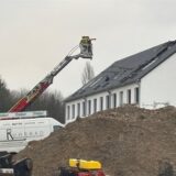 Eine ausgefahrene Drehleiter der Feuerwehr steht vor einem Haus im Neubaugebiet Kirschgärten in Recklinghausen, in dem ein Brand ausgebrochen war.