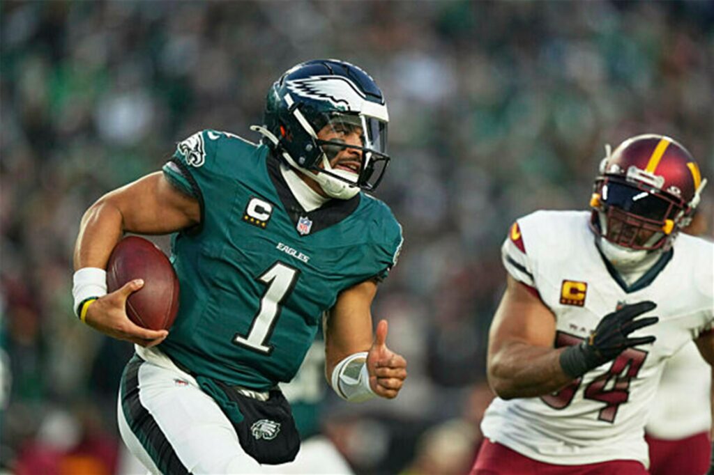 Eagles-Quarterback Jalen Hurts enteilt einem Verteidiger der Washington Commanders.