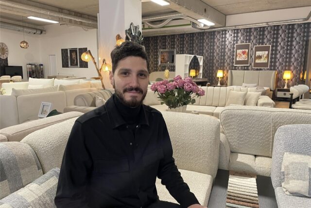 Furkan Bayram sitzt auf einem Sofa in seinem Möbel-Showroom in Lütgendortmund.