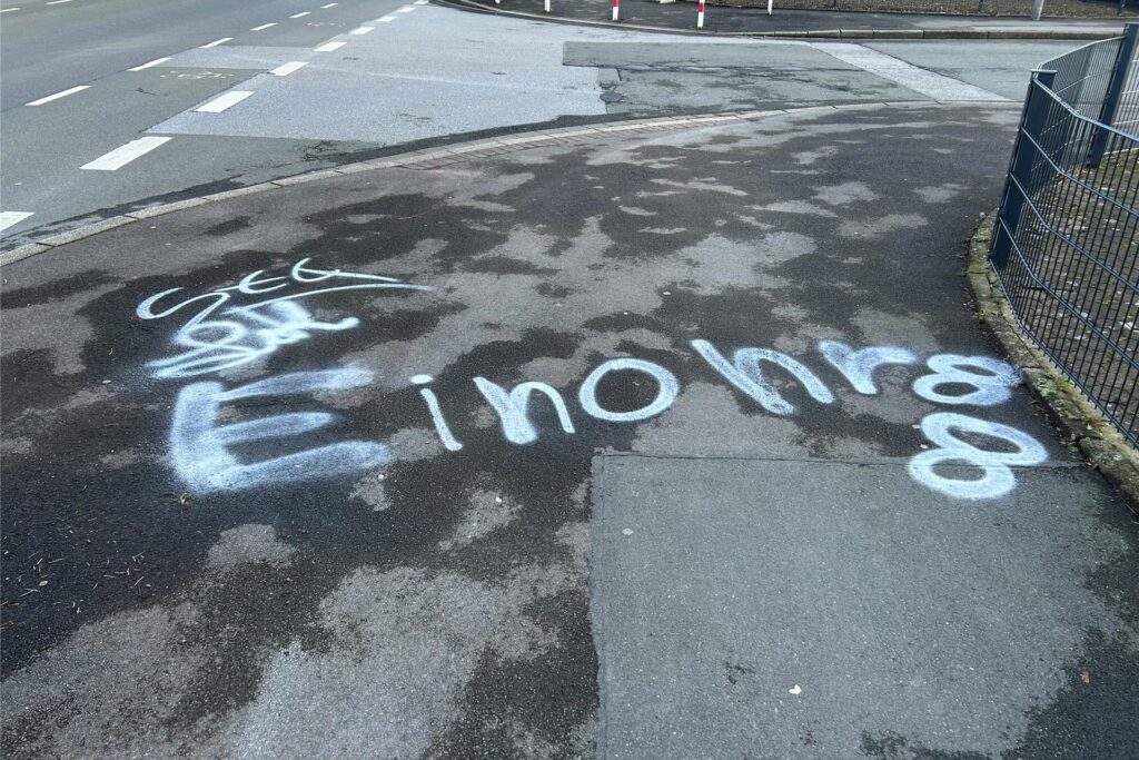 Weißer Schriftzug auf einem Gehweg in Dortmund: Weißer Schriftzug auf einem Gehweg in Dortmund: