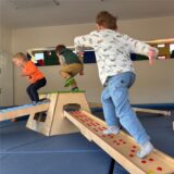 Drei Kinder der St. Josef Kita in Datteln spielen auf dem neuen Balancierparcours
